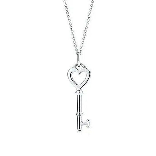 Heart-shaped charm and key pendant necklace on a silver-tone chain