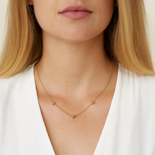Gold-tone chain necklace with double love-knot charm links