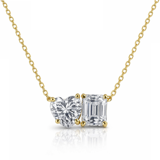 Gold necklace with two diamond pendants on a white background