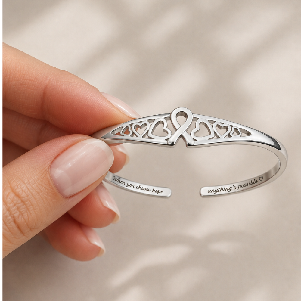 Silver heart-pattern cuff bracelet close-up with inner engraved words