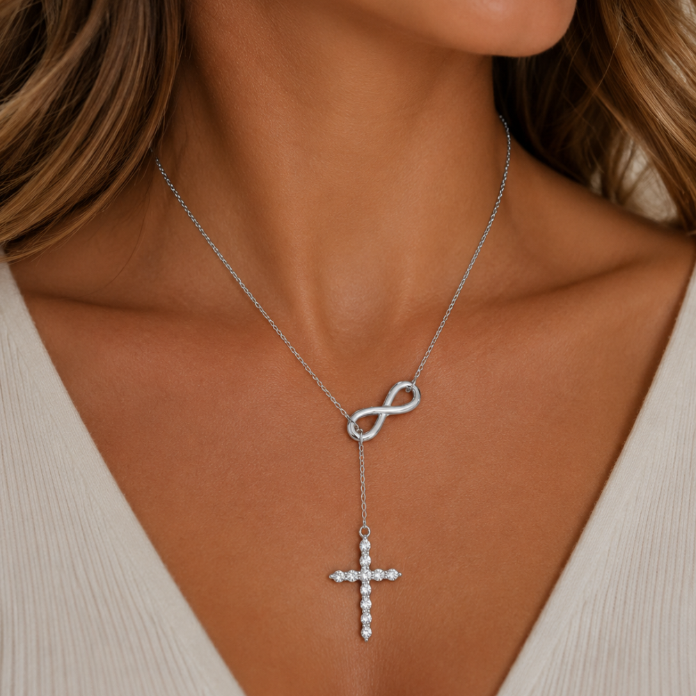 Silver lariat cross necklace with infinity link and sparkling cross drop.