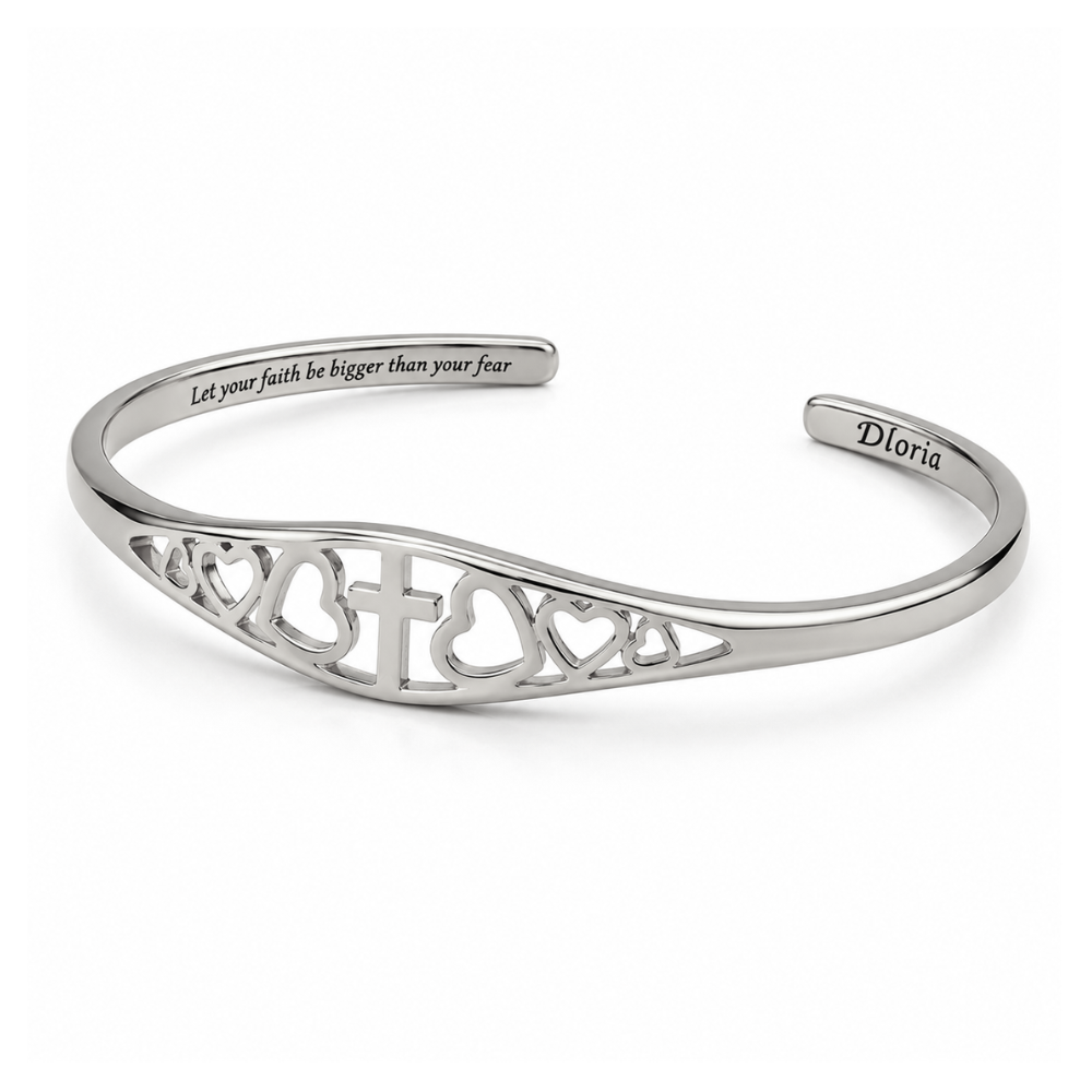 Silver adjustable cuff bracelet with cross and heart cutout design and engraved interior text