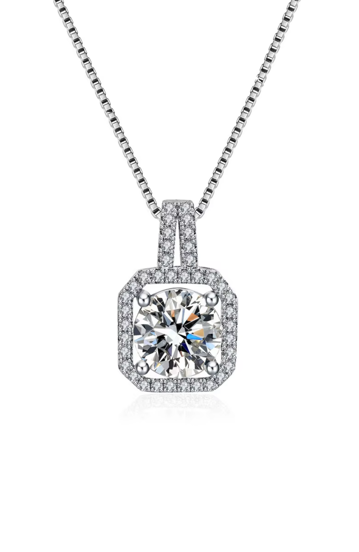 The Two Carat Halo Cubic Zirconia Pendant Necklace features a large, round cz stone surrounded by a square halo of smaller stones, all set in a sleek, silver geometric metal frame.