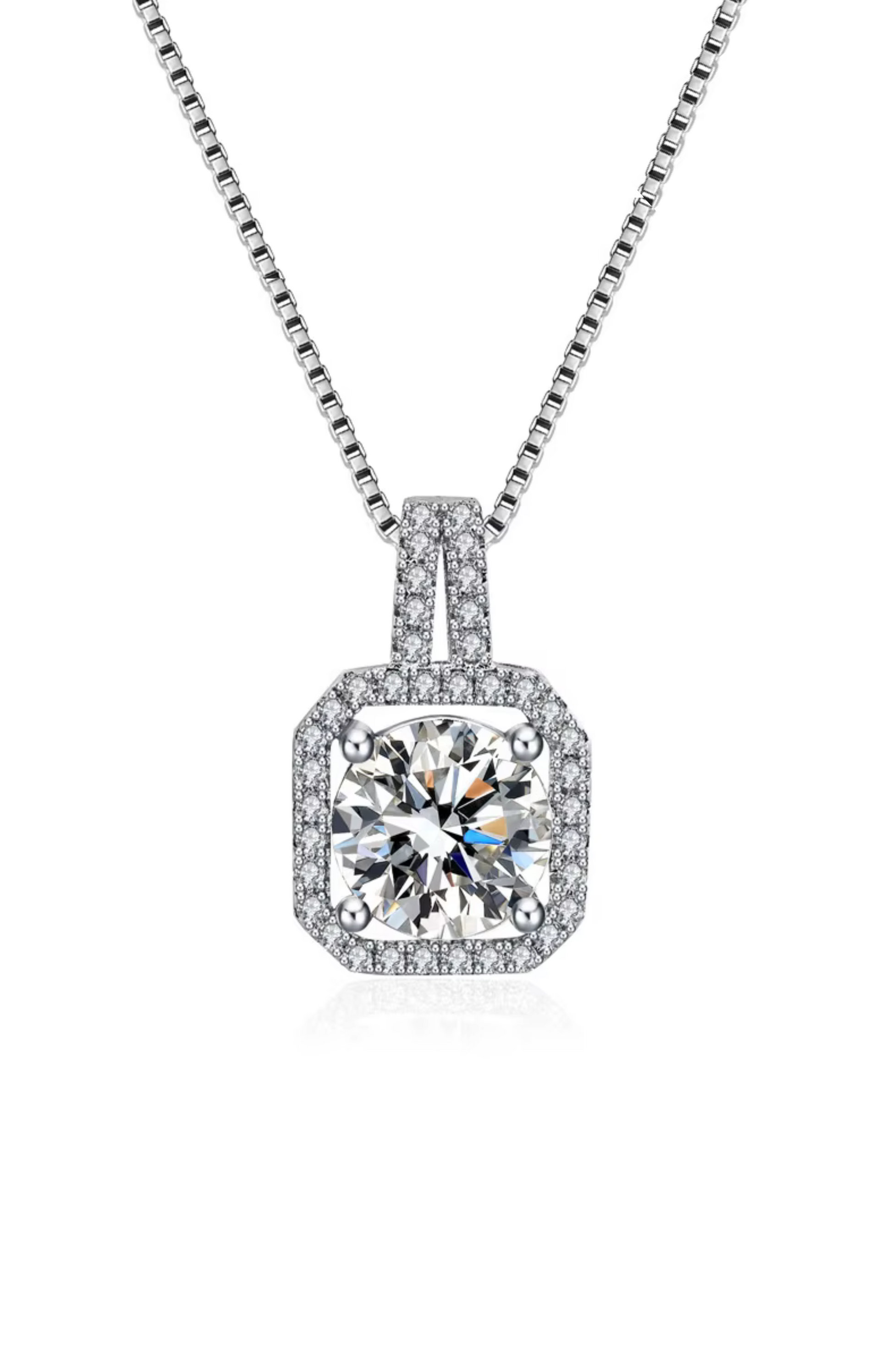 The Two Carat Halo Cubic Zirconia Pendant Necklace features a large, round cz stone surrounded by a square halo of smaller stones, all set in a sleek, silver geometric metal frame.