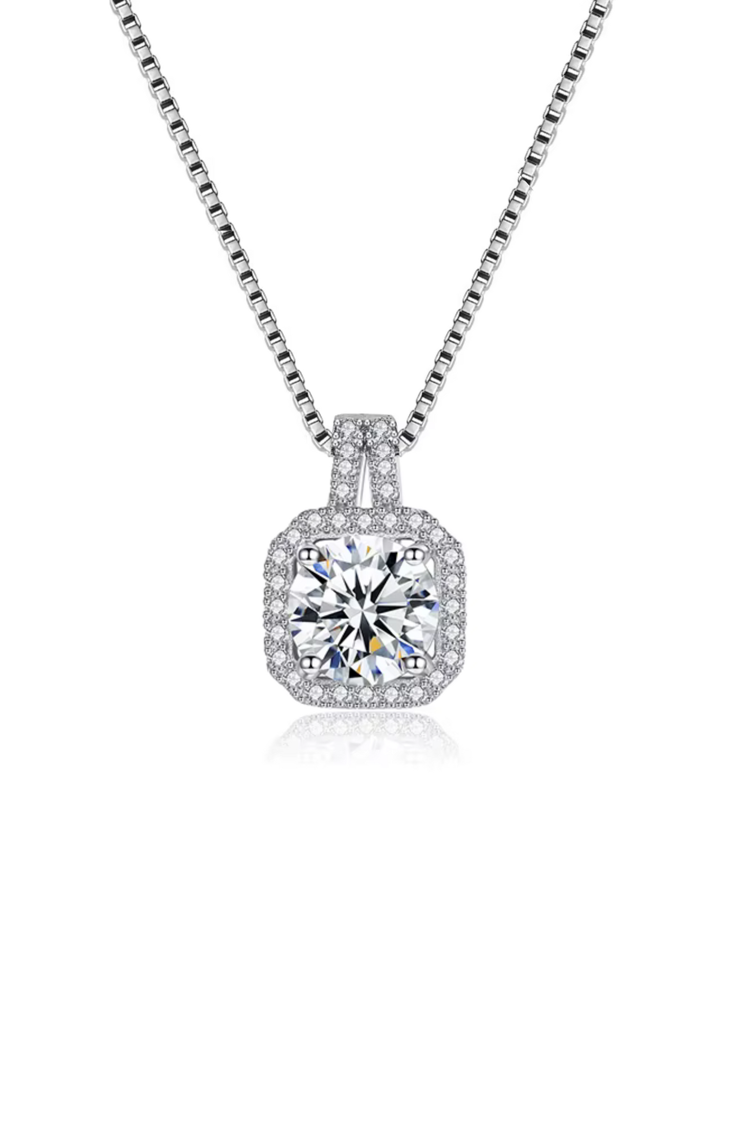 The Two Carat Halo Cubic Zirconia Pendant Necklace features a silver chain with a square-shaped pendant, showcasing a large round center stone encircled by smaller CZ stones.