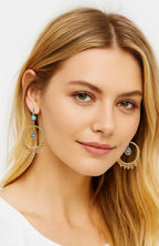 Gold boho hoop earrings with turquoise cabochon and beaded circular center, dangle pair