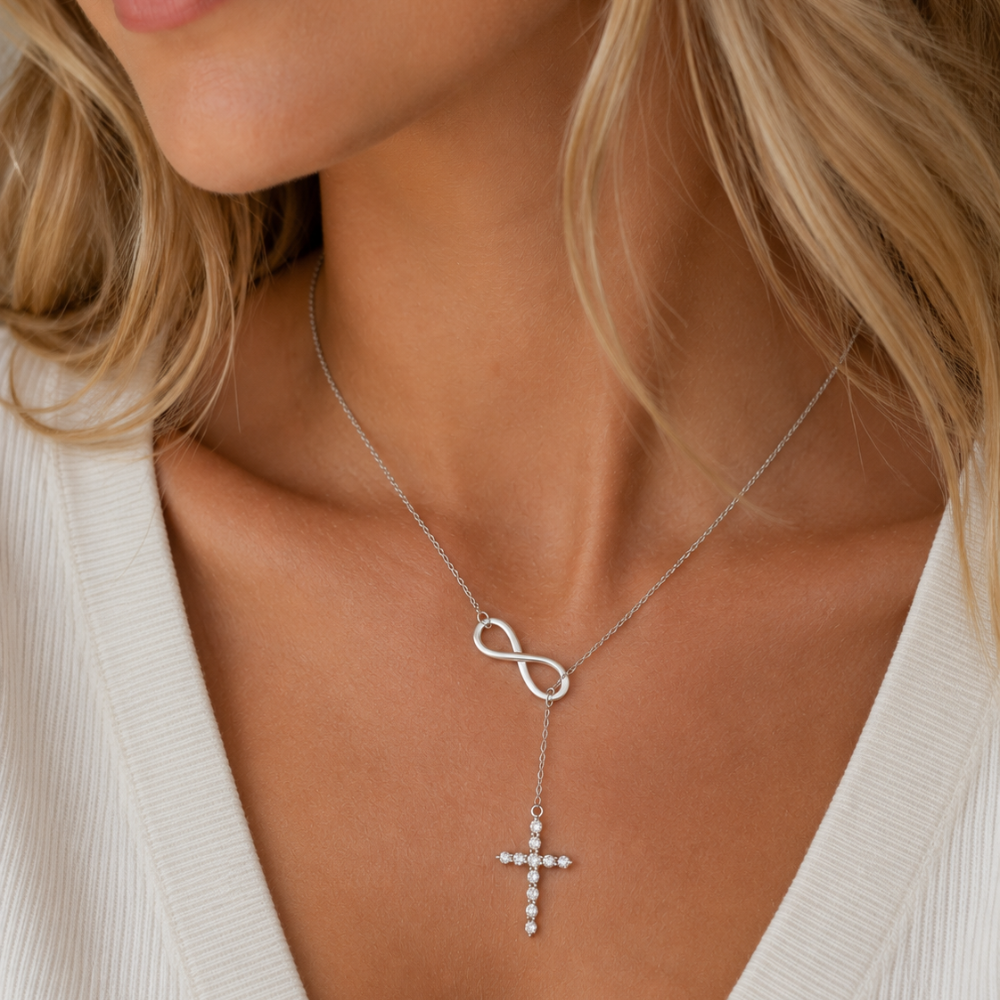 Silver cross lariat necklace featuring infinity loop and sparkly cross drop.