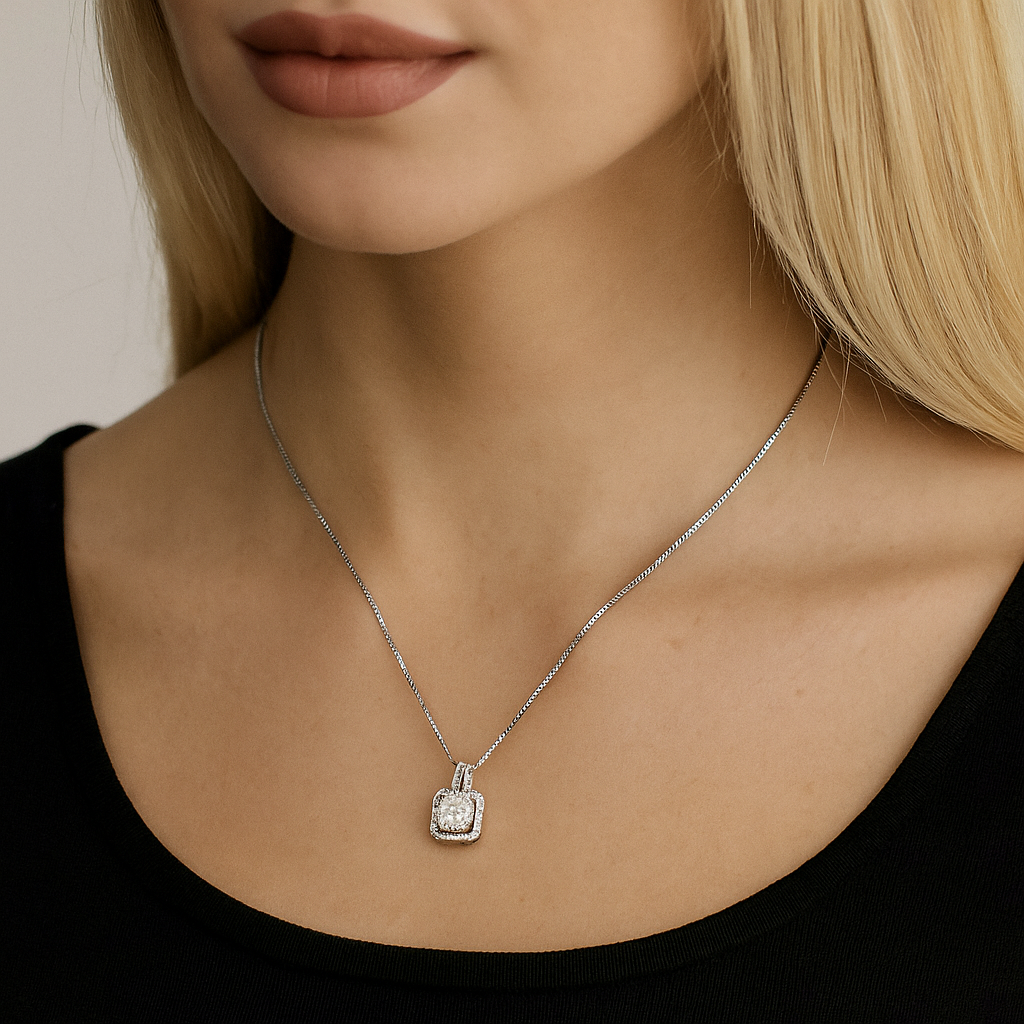 A woman with long blonde hair wears a black top and the Two Carat Halo Cubic Zirconia Pendant Necklace, its sparkling centerpiece elegantly highlighted against her visible lower face, neck, and collarbone.