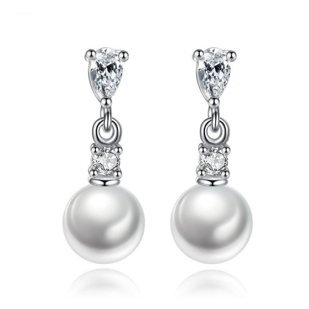 Gold-plated faux pearl drop earrings featuring pear-cut cubic zirconia and round cubic zirconia accents with a classic elegant design.