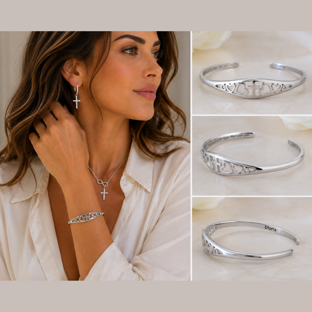 Silver cuff bracelet with engraved cross and hearts, shown from side angles