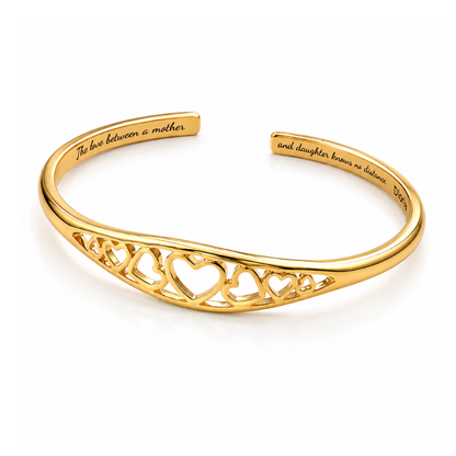 Gold adjustable engraved cuff bracelet with heart filigree along the center bar