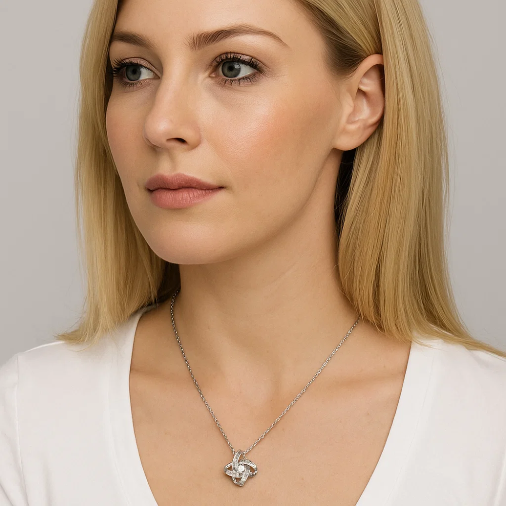 Silver knot pendant necklace with cubic zirconia centerpiece on link chain