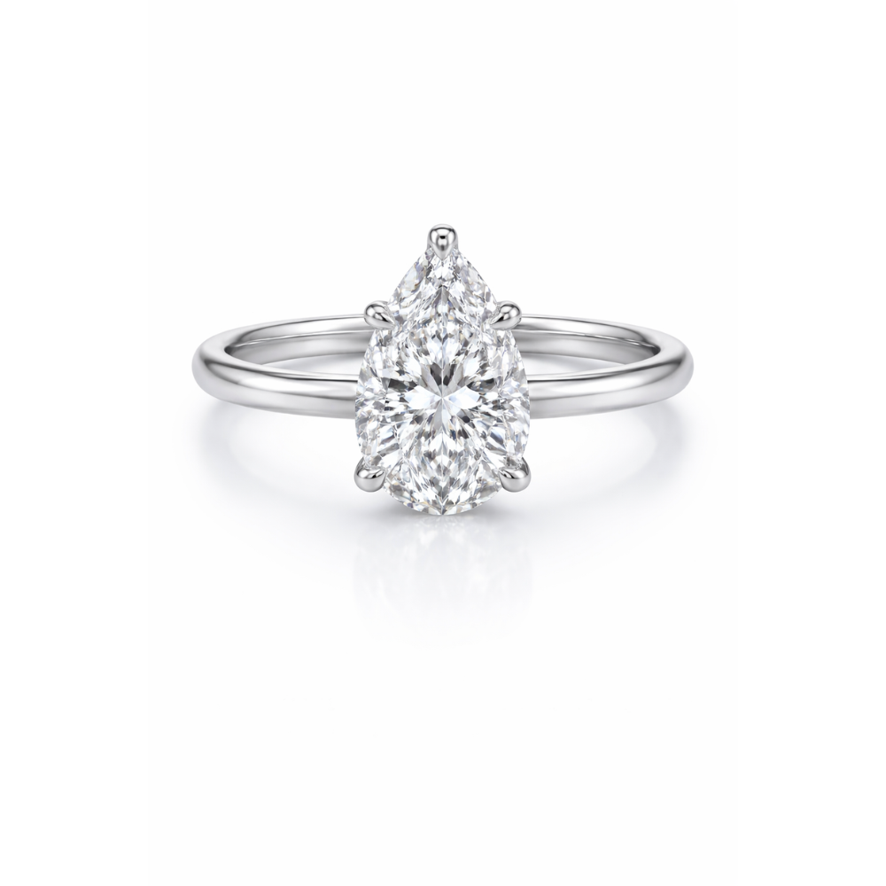 Silver-tone pear-cut moissanite ring with teardrop center stone in studio view.