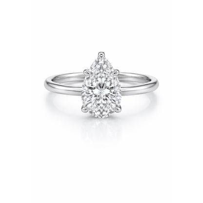 Silver-tone pear-cut moissanite ring with teardrop center stone in studio view.