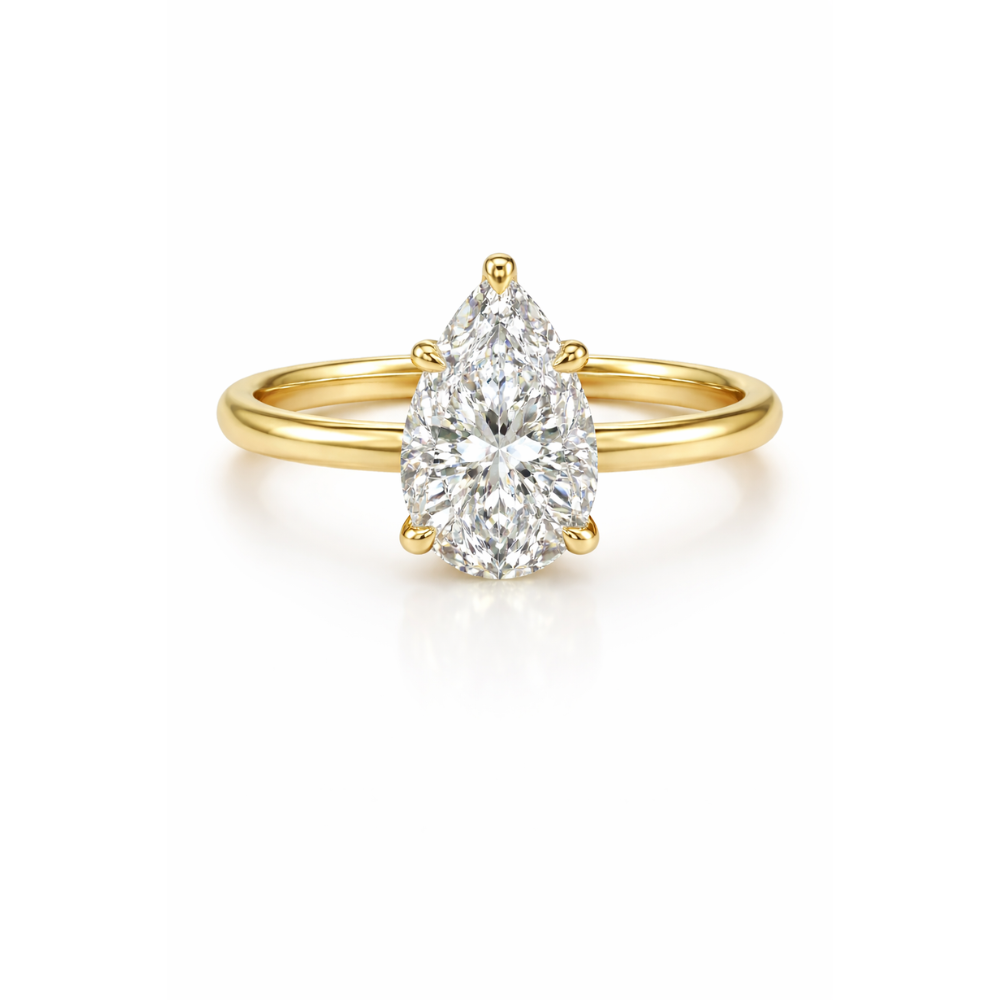Pear-cut moissanite ring in gold-tone metal with a teardrop center stone.