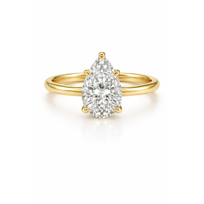 Pear-cut moissanite ring in gold-tone metal with a teardrop center stone.
