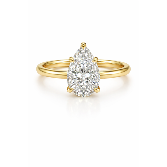 Pear-cut moissanite ring in gold-tone metal with a teardrop center stone.