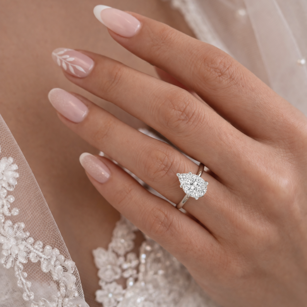 Silver-tone pear-shaped gemstone ring on hand