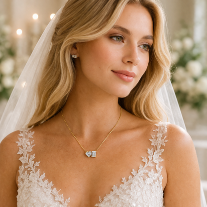 Gold vermeil heart and emerald-cut moissanite necklace worn at the neckline with pendant centered
