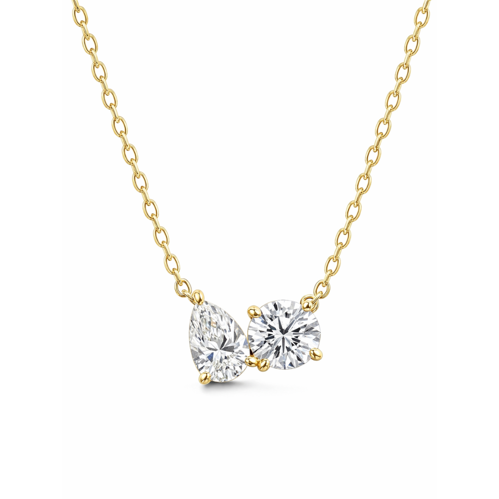 Gold vermeil necklace with pear- and round-cut clear stones on a curb chain