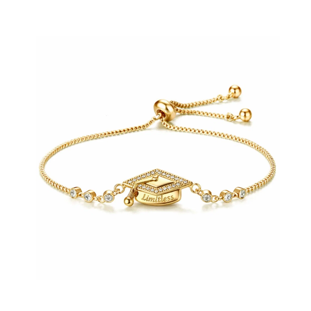 Gold bracelet with a graduation cap charm on a white background