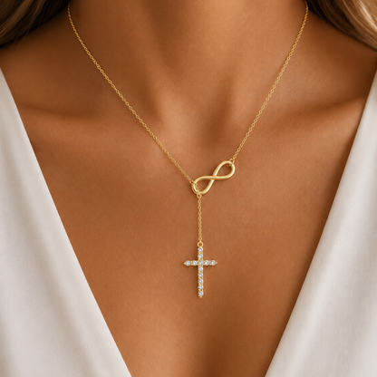 Gold lariat cross necklace close-up: oval clasp and rhinestone cross drop