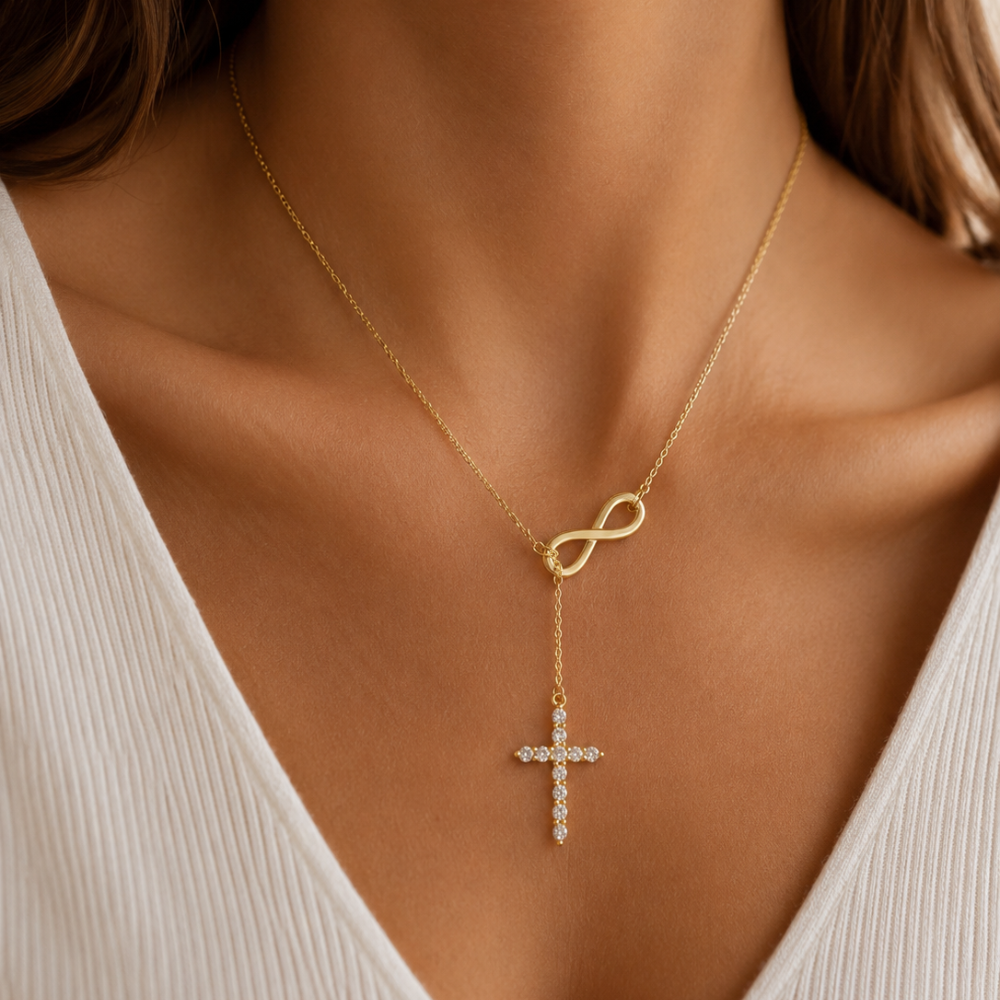 Gold lariat cross necklace close-up with infinity clasp and sparkling cross