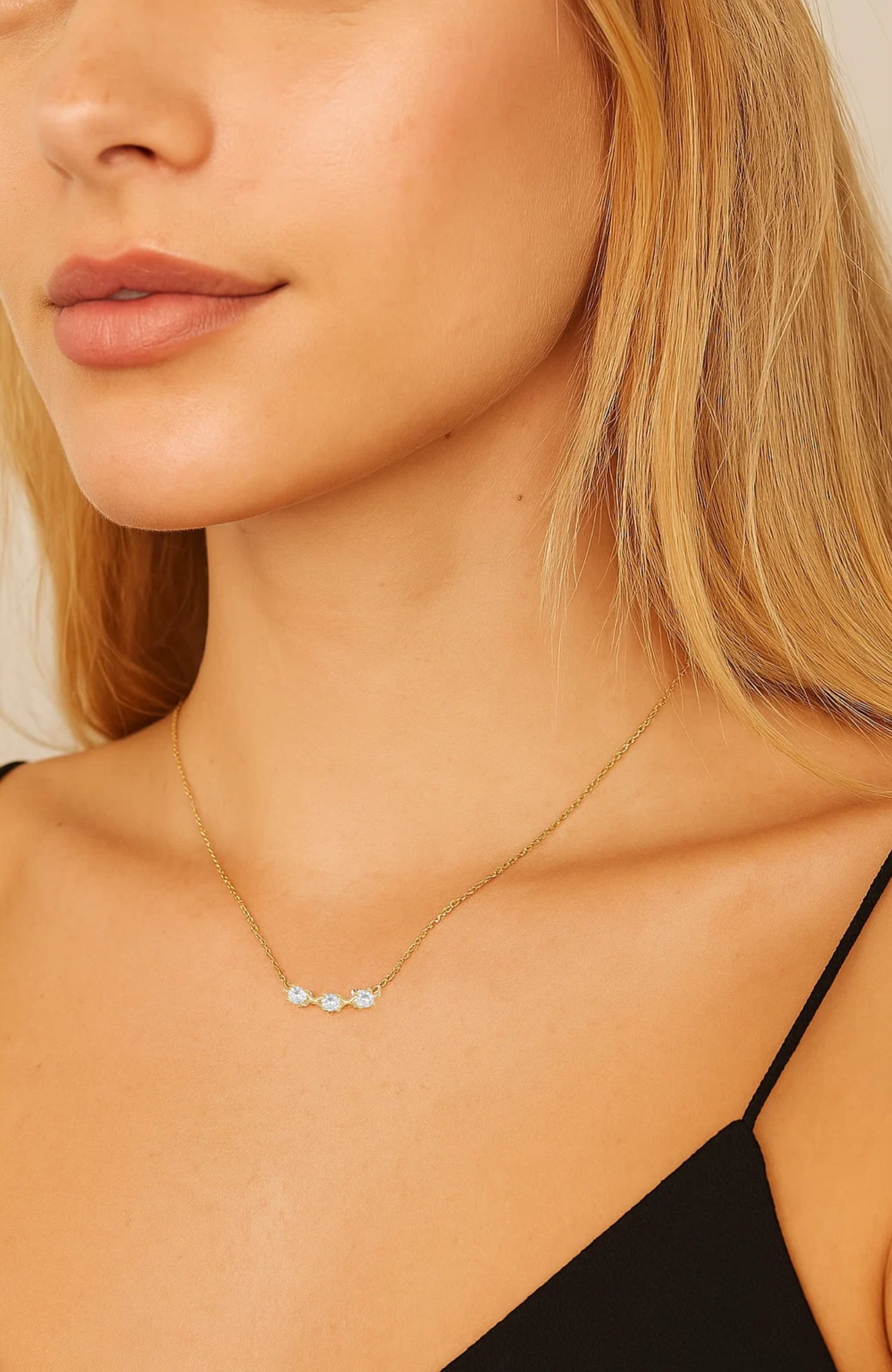 Three-stone gold-tone cubic zirconia necklace with thin chain on model