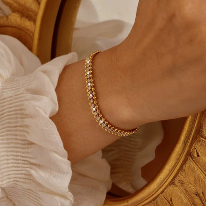 Gold-tone CZ chain bracelet with small round stones, adjustable link fit on wrist.