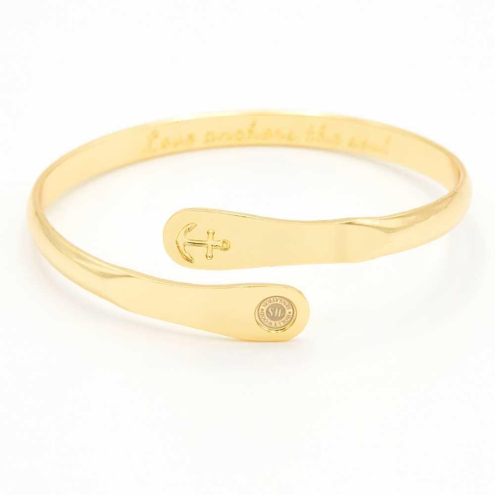 Gold anchor engraved cuff bracelet with oval charm plate and round seal