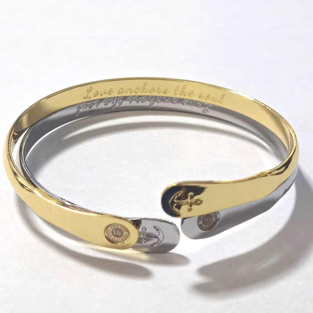Gold tone anchor bracelet showing inner engraving and anchor charm