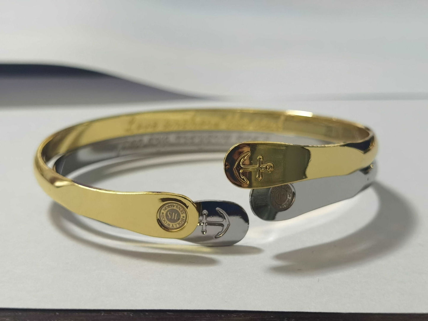 Gold tone anchor bracelet with engraved love anchor charm accents