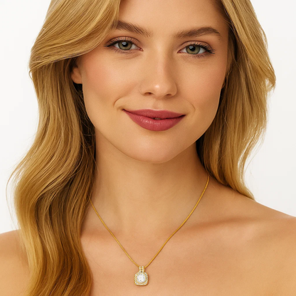 Gold halo pendant necklace with square crystal center and stud earrings on model