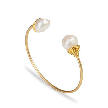 Gold-tone baroque pearl bracelet with two irregular white pearls and wire-wrapped ends