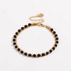 Gold beaded friendship bracelet with black beads in a double-row design
