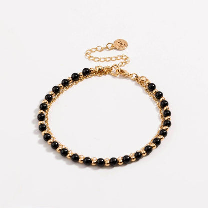 Gold beaded friendship bracelet with black beads in a double-row design