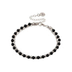 Silver-tone beaded friendship bracelet with black beads and round charm tag clasp