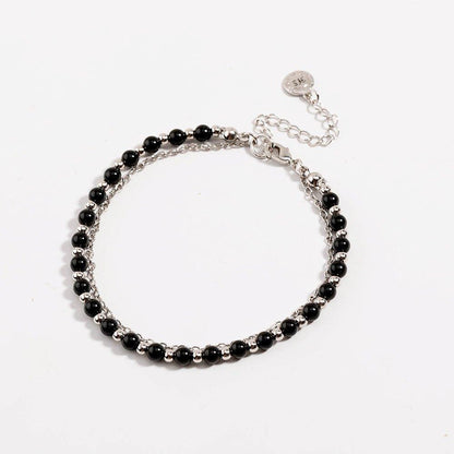 Silver beaded friendship bracelet with black bead rows and round tag charm