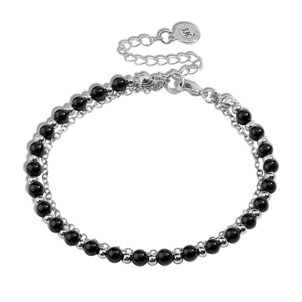 Silver beaded friendship bracelet with black beads and small round charm