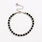 Silver beaded friendship bracelet with glossy black beads and round charm