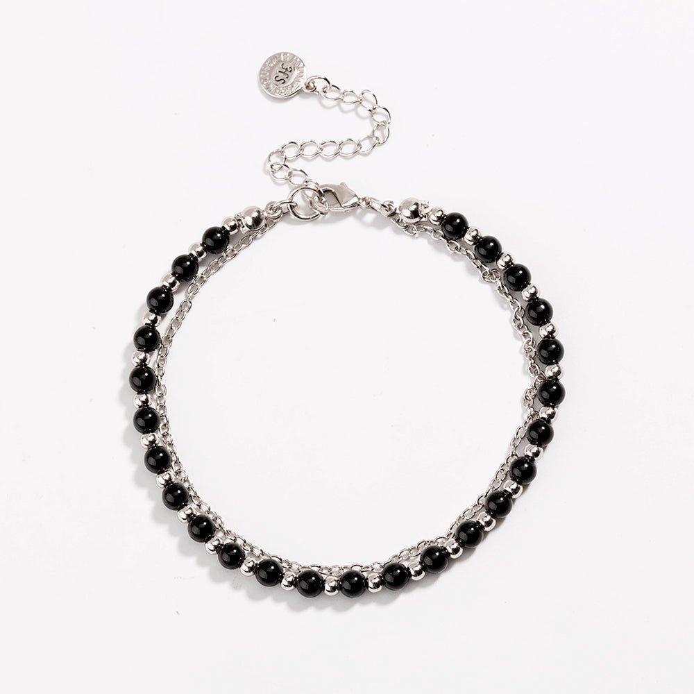 Silver beaded friendship bracelet with glossy black beads and round charm