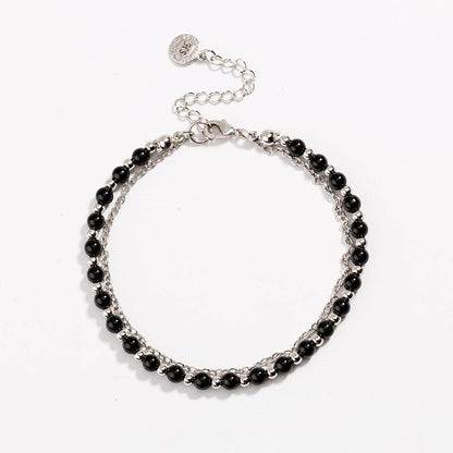 Silver beaded friendship bracelet with glossy black beads and round charm