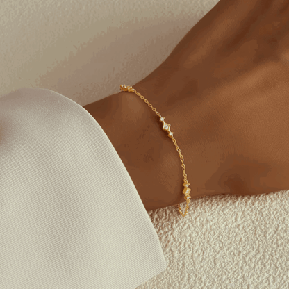 Gold-tone chain link bracelet with small geometric cubic zirconia accents