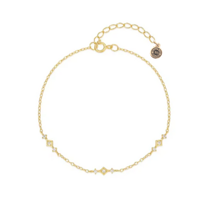 Gold-tone chain link bracelet with geometric zirconia stations and clasp