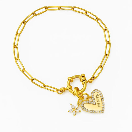 Gold chain bracelet with dangling heart charm and star-shaped sparkle