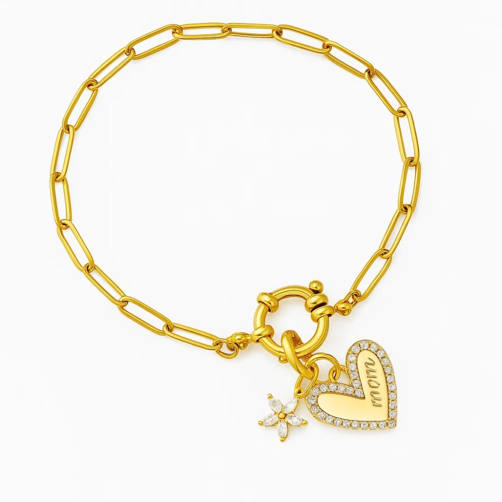Gold chain bracelet with dangling heart charm and star-shaped sparkle