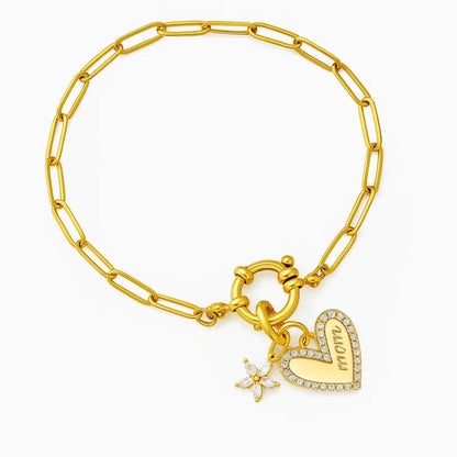 Gold chain bracelet with dangling heart charm and star-shaped sparkle