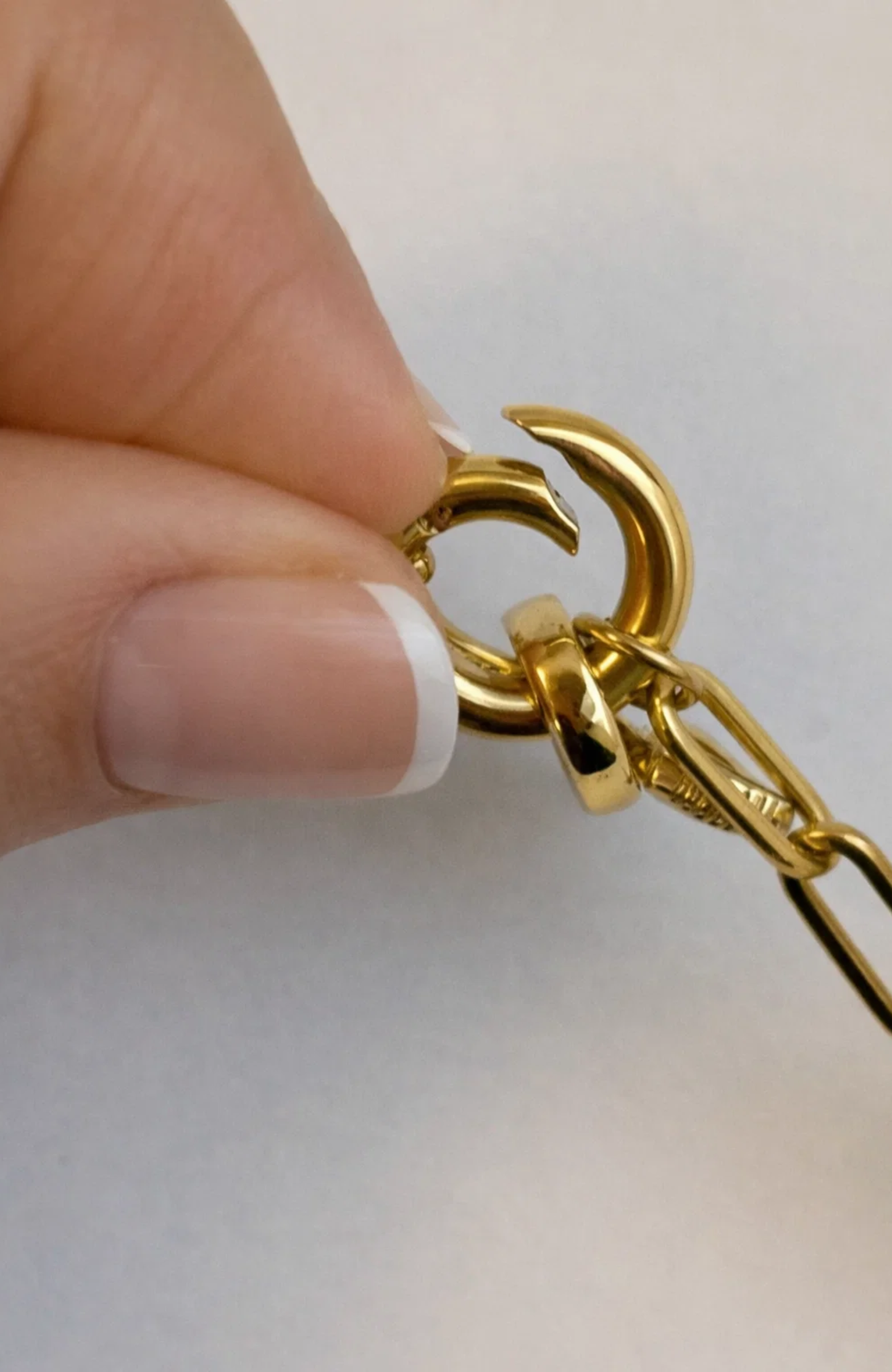 Gold tone necklace clasp and link chain with heart charm detail
