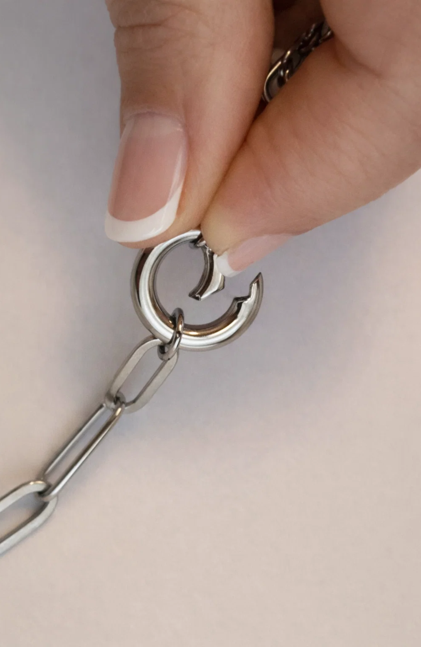 Silver chain necklace clasp with linked rings and small round hoop close-up