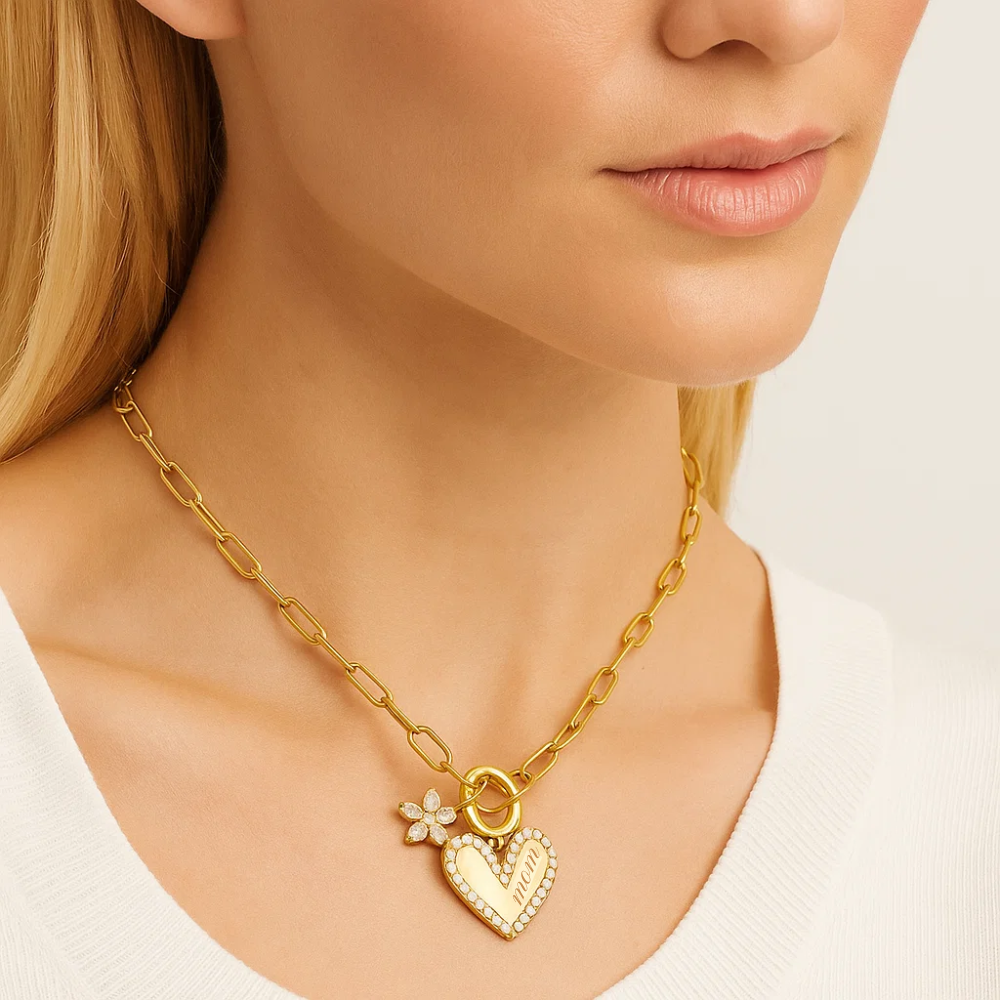 Gold chain necklace with heart pendant and small flower charm